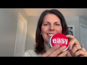Coach holding an “easy” button, reflecting on choosing ease in everyday decisions